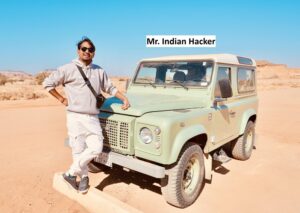 2. Mr. Indian Hacker poses next to a Land Rover Defender 90, highlighting his identity as a tech enthusiast.